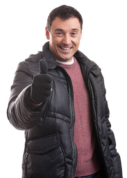 istock Handsome man in a down jacket showing his thumbs up 475676034
