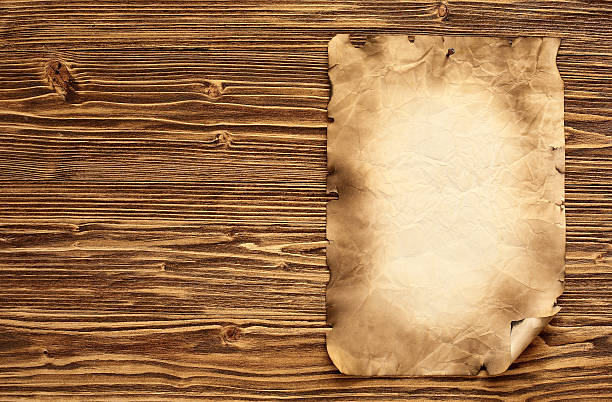istock Old paper on brown wooden background 475678659