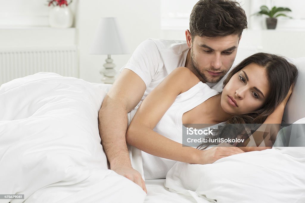 Conflict in bedroom portrait of unhappy young heterosexual couple in bedroom Bed - Furniture Stock Photo