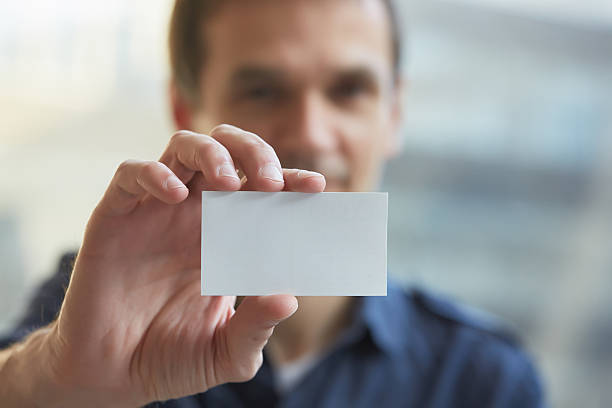 istock businessman giving a business card 475681988