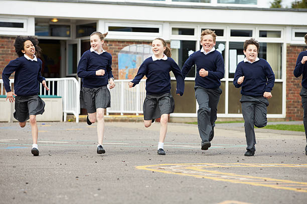 istock Group Of Elementary School Pupils Running In Playground 475684203