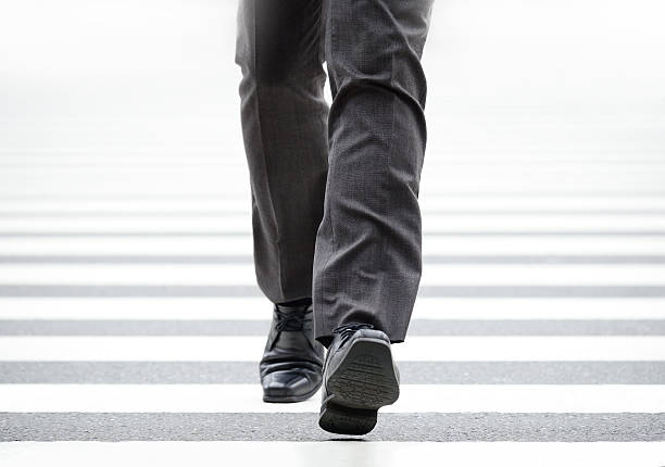 istock Suit crossing street, bright light 475684448