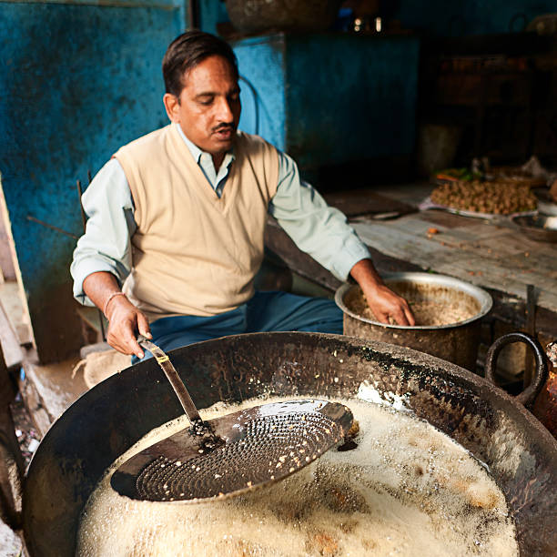 istock Indian street vendor preparing food 475684500