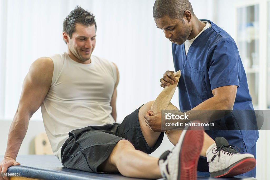 Physical Therapy An athlete receiving rehibilitative care for a sports injury. Athlete Stock Photo