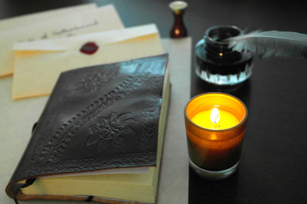 istock Old leather Diary, Victorian Feather Quill and Candle 475693176