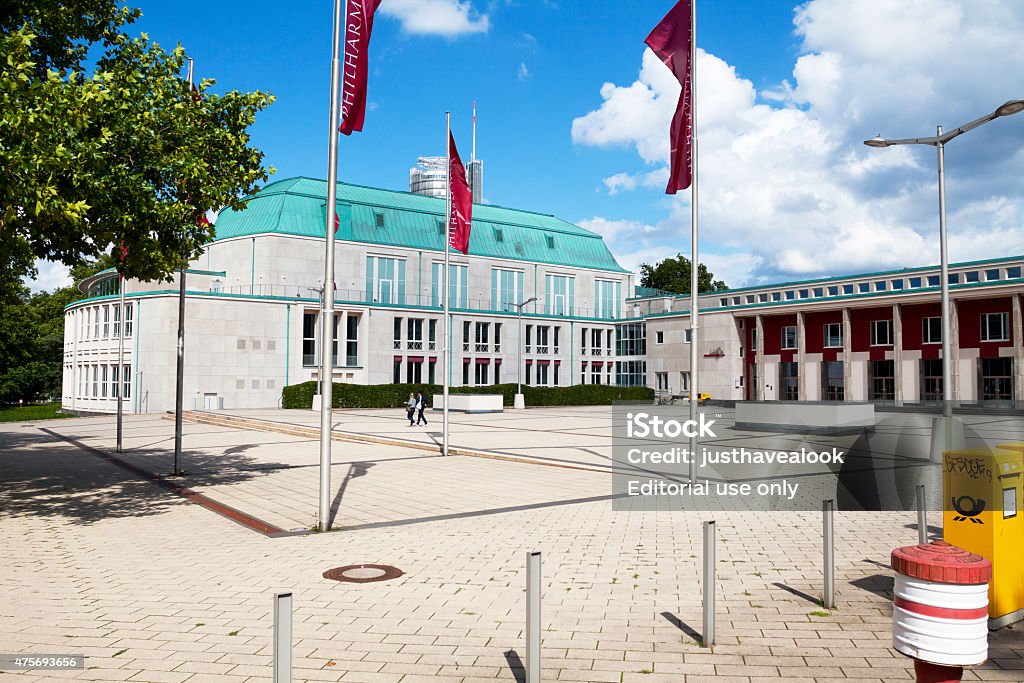 Art-deco building Philharmony of Essen Essen, Germany - August 7, 2011: Art-deco building Philharmony of Essen in summer, sunny day. View over square. Two women are crossing square. 2015 Stock Photo