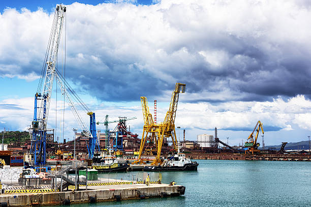 Cranes and moored boats, Industrial Port of Piombino, Italy stock photo