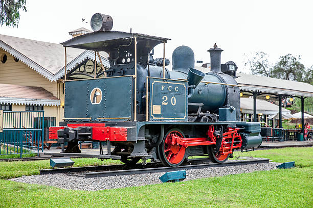 Lima, Peru - January 21, 2015: Vintage Peruvian steam train in Lima park Parque de la Amistad. People are pictured sitting in the background