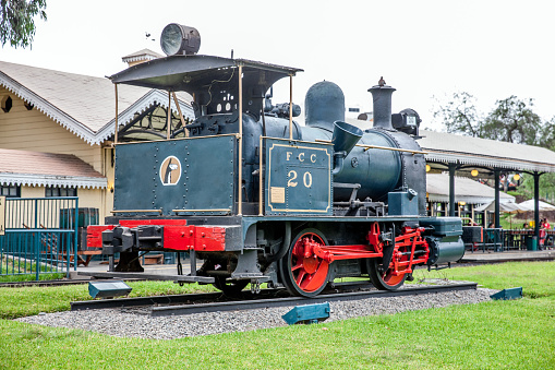 Lima, Peru - January 21, 2015: Vintage Peruvian steam train in Lima park Parque de la Amistad. People are pictured sitting in the background