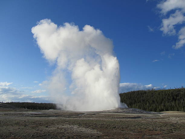 istock Old Faithful erupting geyser 475699505