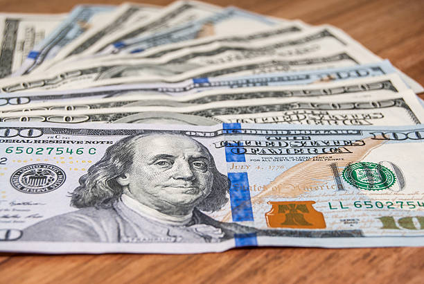 istock new usa one hundred dollar bills on wooden table 475699802