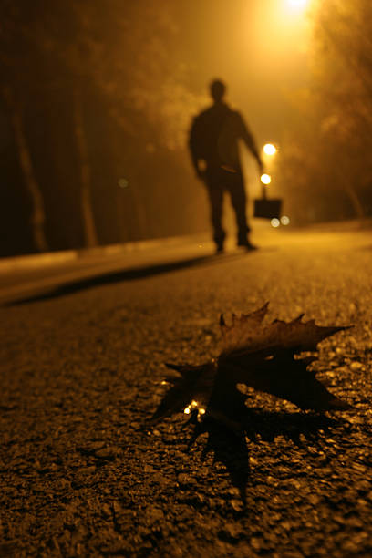 man walking on the street alone at night