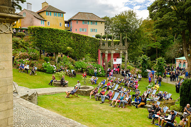 People seated, some clapping after performance Festival No.6, Portmeirion Portmeirion, Wales - September 6, 2014: People seated, some clapping during a performance, in the Central Piazza, during 'Festival No.6'. In Portmeirion, North Wales, UK. portmeirion stock pictures, royalty-free photos & images