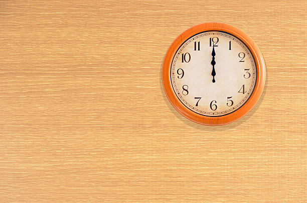 istock Clock showing 12 o'clock on a wooden wall 475703932