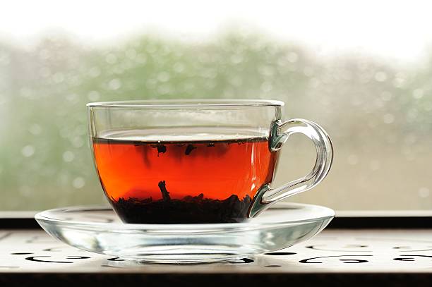 istock Shu puerh tea brewed in glass cup on window sill 475705224