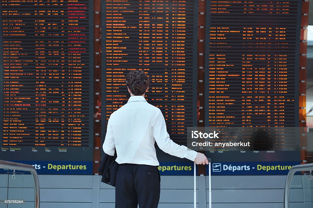 passenger looking at timetable board passenger looking at timetable board at the airport Airport Stock Photo