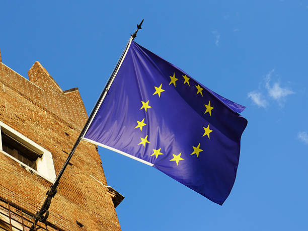 European Union Flag European Union flag in a sunny day on blue and clean sky. Emblem of EU and Council of Europe. desiderius erasmus stock pictures, royalty-free photos & images