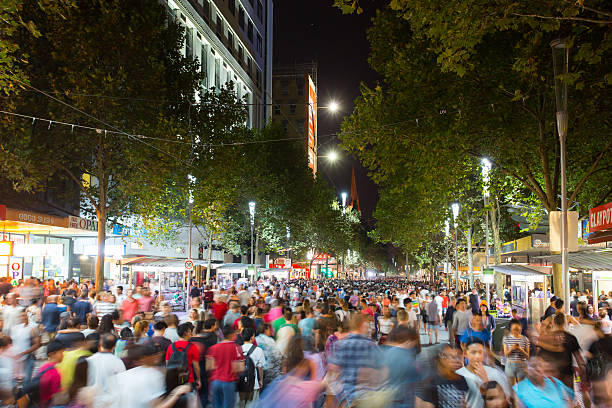 White Night Melbourne 2015 Melbourne, Australia - February 21, 2015 - Melbourne's famous Swanston St with large crowd at White Night celebration. melbourne street crowd stock pictures, royalty-free photos & images