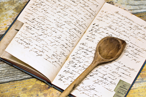 Grandmothers cookbook with spoon on the kitchen table