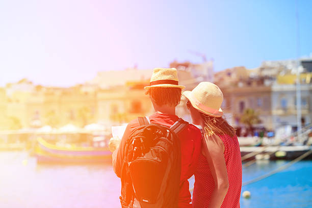 istock tourist couple looking at map while travel in Malta 475705892