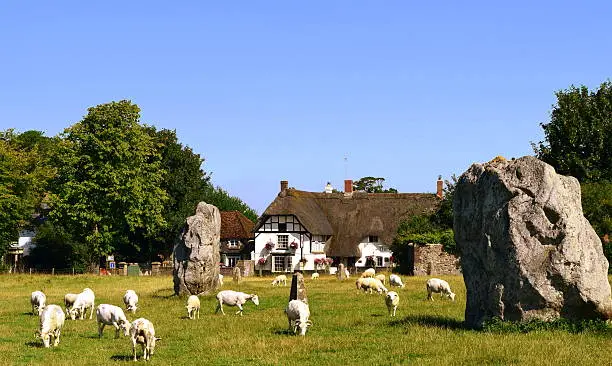 A sunlit view of large ancient standing stones and the village of Avebury north Wiltshire. Avebury is the largest, most impressive and complex prehistoric site in Britain and in my opinion far more impressive than Stone Henge although less iconic