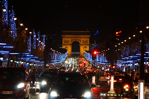 Paris, France - December 30, 2013: The festive decorated Champs-Elysées with jam on the road and the Arc de Triomphe at their end on December 30, 2013 in Paris.