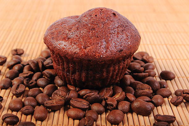 istock Fresh baked chocolate muffins and coffee grains 475706232