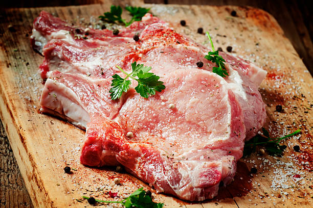 istock Raw meat steak with spices on wooden board, selective focus 475706432