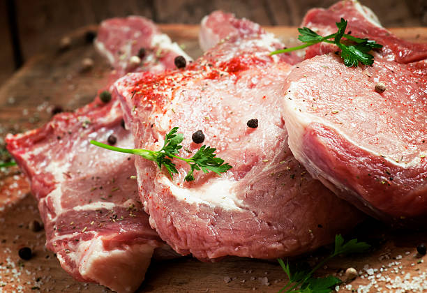 istock Raw meat steak with spices on wooden board, selective focus 475706440