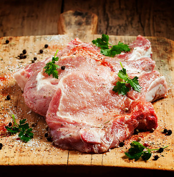 istock Raw meat steak with spices on wooden board, selective focus 475706654
