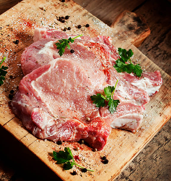 istock Raw meat steak with spices on wooden board, selective focus 475706664