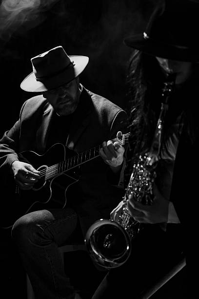 Sax and Guitar Sax lady with a guitarist acoustic guitar photos stock pictures, royalty-free photos & images