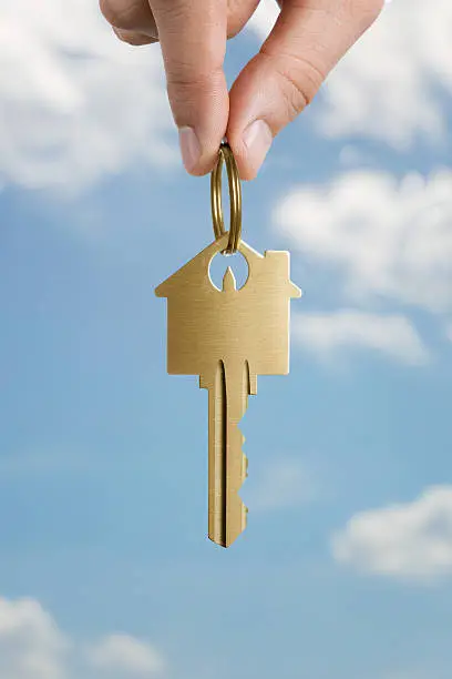 Photo of Human hand holding house shaped key