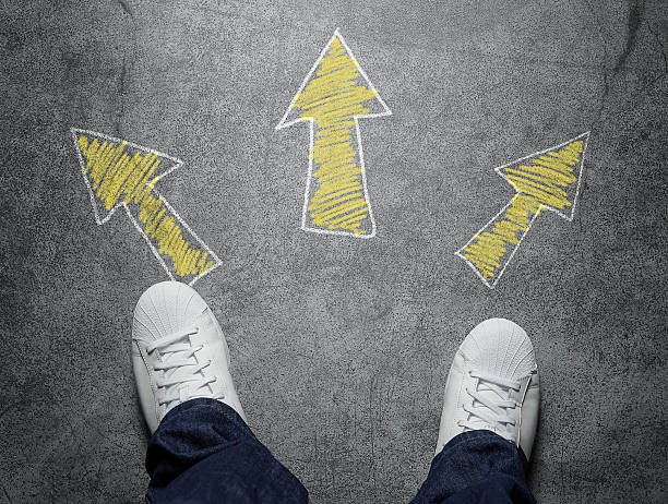 Decisions High angle view of three arrows drawn on the street, pointed in different directions directing photos stock pictures, royalty-free photos & images