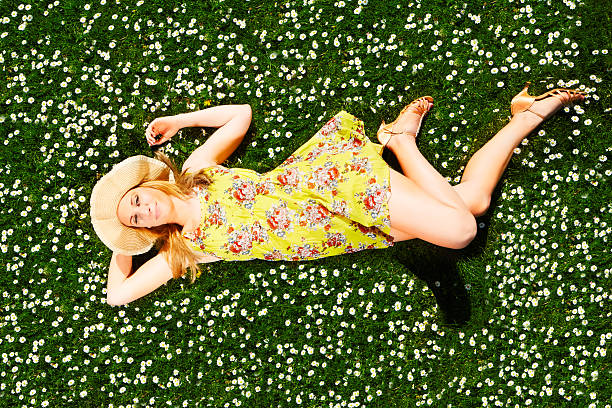 istock Blonde girl on a flower meadow 475709582