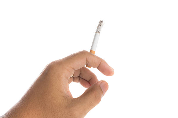istock Man hand holding burning cigarette isolated on white background 475709758