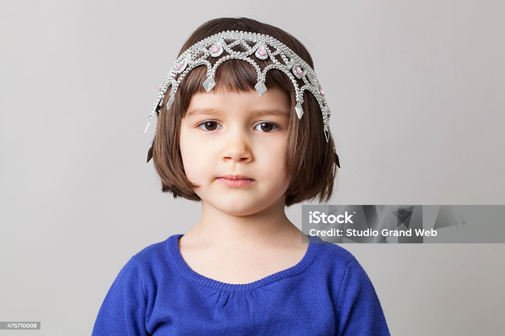 adorable young girl with crown upside down on her head cute preschool child with tiara for fun beauty awards or mollycoddled infant 2-3 Years Stock Photo