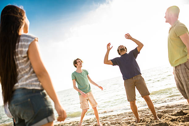 istock friends playing volleyball on the beach 475710182
