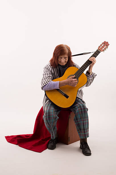 istock Funny elderly lady playing acoustic guitar 475712630