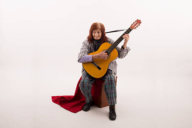 istock Funny elderly lady playing acoustic guitar 475713266