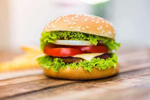 istock Hamburger on wood table ,sun flare filter effect 475713696