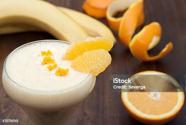 Cocktail Of Banana With Orange And Yogurt Stock Photo - Download Image Now - Backgrounds, Banana, Beige