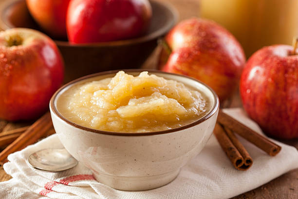 Healthy Organic Applesauce with Cinnamon Healthy Organic Applesauce with Cinnamon in a Bowl compote stock pictures, royalty-free photos & images