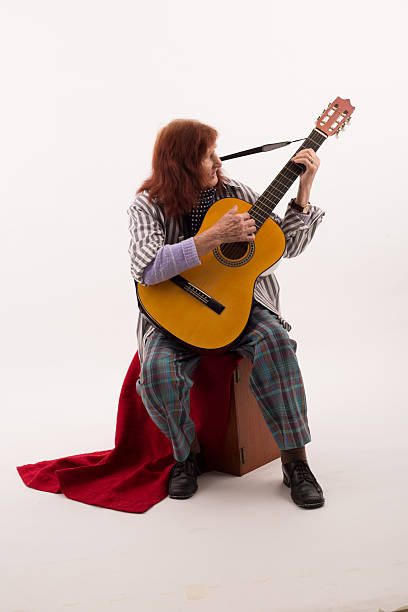 istock Funny elderly lady playing acoustic guitar 475714254