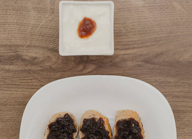 istock Jam on slices of bread and yogurt in white bowl 475715542