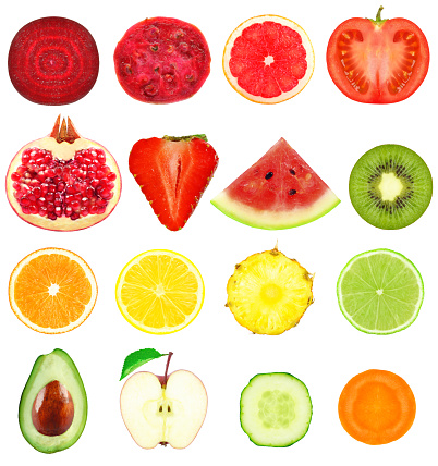 Fresh slices of fruits and vegetables on a white background