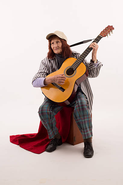 istock Funny elderly lady playing acoustic guitar 475716346