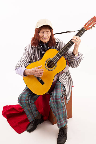 istock Funny elderly lady playing acoustic guitar 475718576