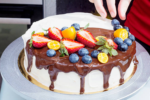 istock Chef decorates berry cake with blueberries 475722544