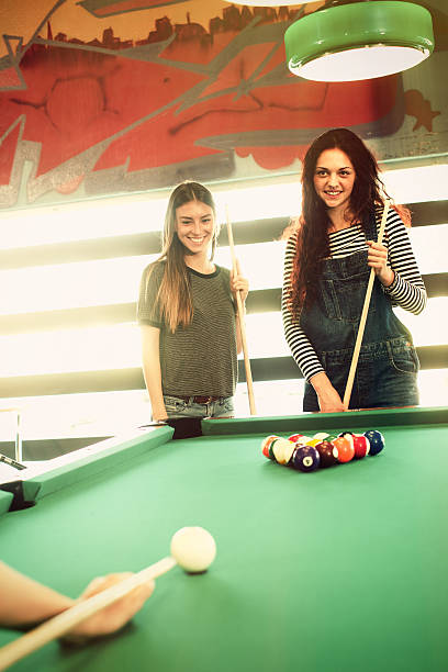 istock Three friends having fun and playing snooker 475722720